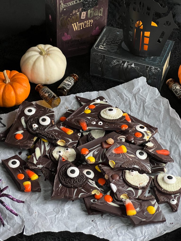 halloween chocolate bark pieces, pumpkins and books, haunted house candle.