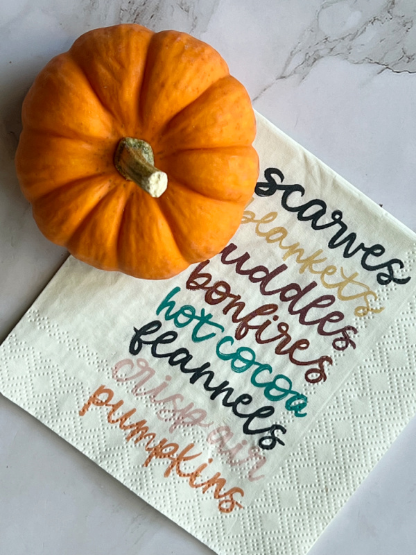 Preparing for Fall after 50, orange pumpkin and a napkin with a list of fall bucket list items.