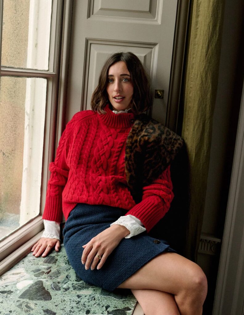 Red roll neck sweater.