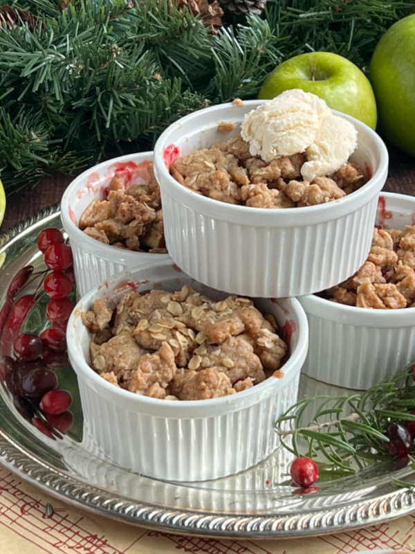 cranberry apple crisp in ramekins stacked.