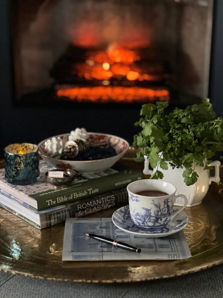 Morning ritual after 50 — toile cup of drinking chocolate gratitude journal and spring green in window light