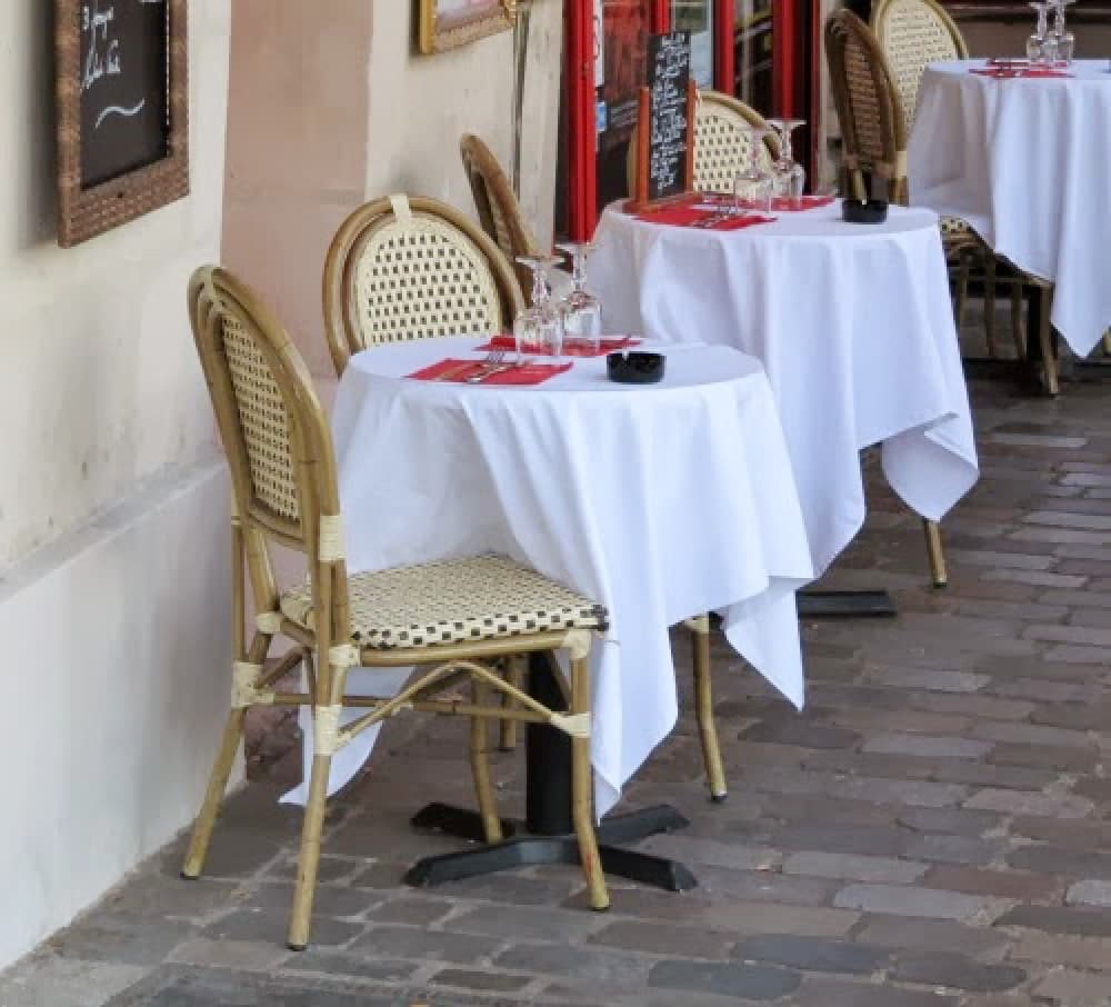 cafe in Paris with white tablecloths in the spring.