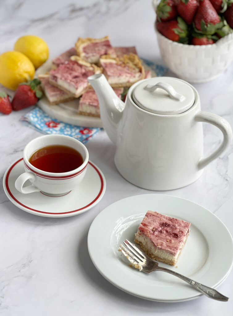 cheesecake bars tea and a basket of berries