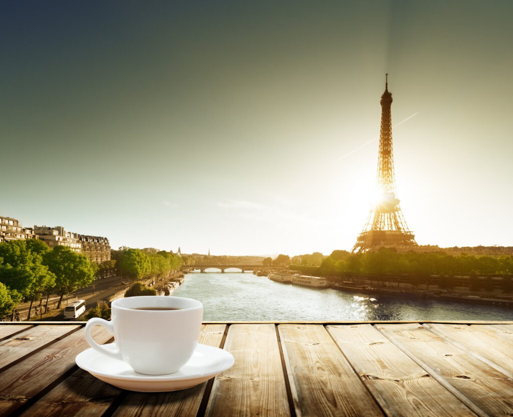 Cup of coffee with the Eiffel Tower in the background--an invitation begin