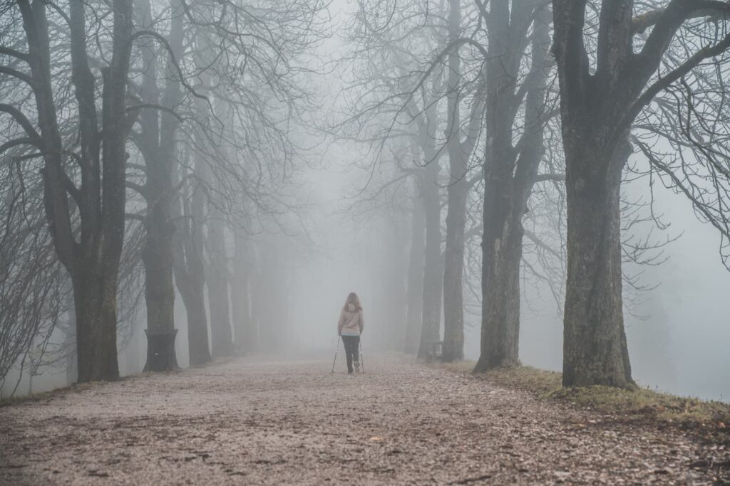 Woman walking in the mist 